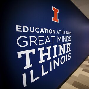 Side perspective view of blue wall with Block I and text 'Education at Illinois Great Minds Think Illinois'